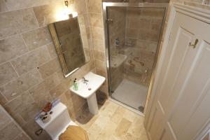a bathroom with a shower and a sink and a toilet at The Cornmill in Kirkbymoorside