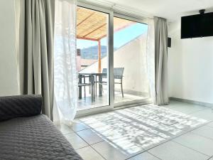 a bedroom with a sliding glass door to a balcony at The AP Fiumaretta in Ameglia