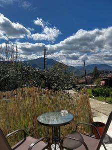 a table and chairs on a patio with a fence at Catch n relax in Kalabaka