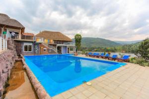 an image of a swimming pool in a house at Kingfisher Resort-Muhazi in Karagari
