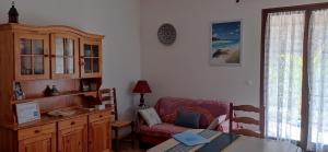 a living room with a couch and a table at Au coeur de la Provence Verte in Le Cannet-des-Maures