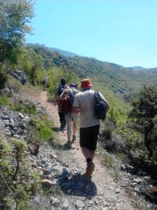 a group of people walking down a rocky trail at Luccia Apartments - Ohrid City Centre in Ohrid