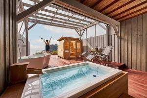 a person is standing in a bath tub on a deck at il azzurri in Nishiizu