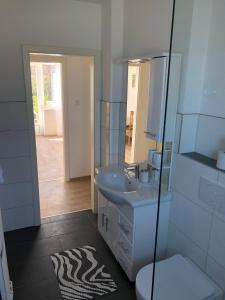 a bathroom with a sink and a toilet and a mirror at Lotus 4 in Cuxhaven