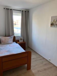 a bedroom with a bed and a window at Lotus 4 in Cuxhaven