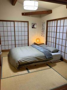 a bedroom with two beds in a room with gates at 『一軒丸々貸切』徒歩5分圏内カフェ 自然を満喫 Modern Ski Chalet +WiFi & 5min walk to cafes. in Nagano