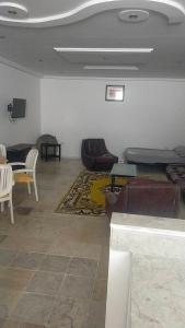 a living room with a couch and a table at Maison pieds dans l'eau in Sousse