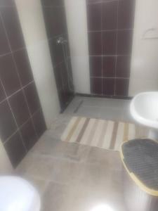 a bathroom with two sinks and a toilet and a shower at Maison pieds dans l'eau in Sousse