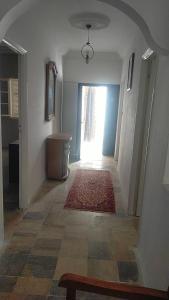a hallway with a room with a rug on the floor at Maison pieds dans l'eau in Sousse