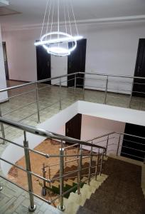 a large room with stairs and a large chandelier at Den House in Myslovka