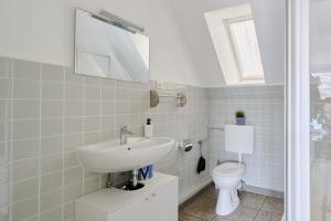 a bathroom with a sink and a toilet at Ferienwohnung Trave Ufer Moba-Travel in Lübeck