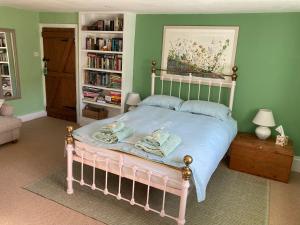 a bedroom with a bed and a book shelf at Corner House in Cudworth