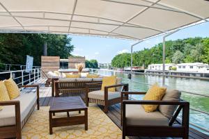 a deck on a boat with chairs and tables at Escale Sur Seine in Paris