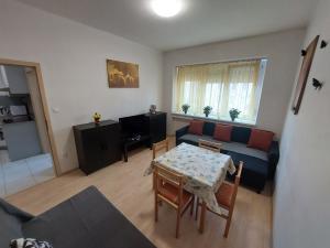 a living room with a table and a couch at Apartmán v centre Bratislavy in Bratislava