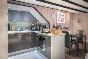 a kitchen with a counter and a table in it at Cosy Cottage in Lytham St Annes - close to beach in Saint Annes on the Sea