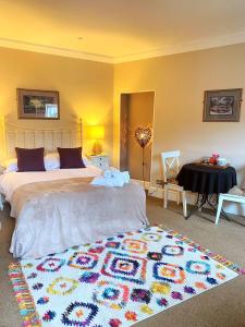 a bedroom with a large bed with a rug on the floor at Cobbleview Rooms in Whitby