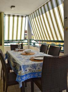 a dining room with a table with chairs and windows at Il Sestante Santa Marinella in Santa Marinella