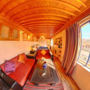 a living room with a couch and a table at Riad Dar Moulay Ali in Marrakesh