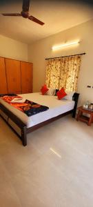 a bedroom with a large bed and a window at Royal Black Pepper Cottage in Yercaud