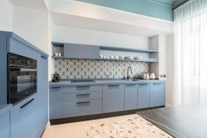 a kitchen with blue cabinets and a stove at Be Mate Trastevere II in Rome