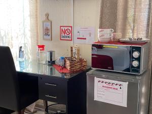 a counter with a microwave on top of a table at Christa's Place 897 in Pretoria