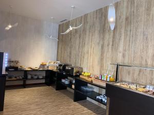 a restaurant with a counter with food on it at Hotel Farol in Praia da Barra