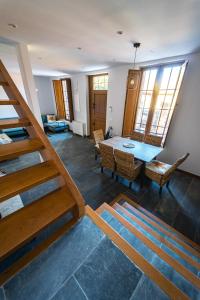 a dining room and living room with a table and chairs at Villa Covadonga by beBalmy in Pedruño