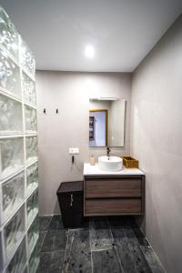 a bathroom with a sink and a mirror at Villa Covadonga by beBalmy in Pedruño