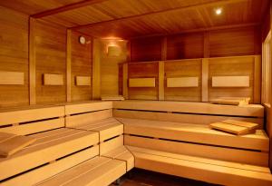 a sauna with wooden walls and benches in it at Hotel Sonnenhügel in Bad Kissingen