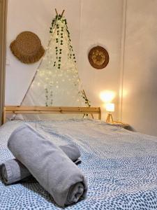 a bedroom with a bed with a christmas tree at L'appart & de la Turdine à L'arbresle entrée autonome in Éveux