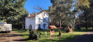 a white house with a sign in front of it at Gites-Cyclistes-Léon in Léon