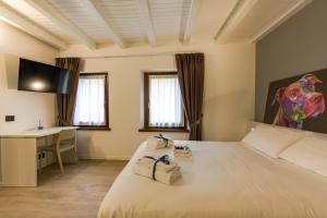Habitación de hotel con cama y escritorio en Le Tofane, vivi la bellezza di Belluno - Stella Alpina, en Sòis