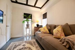 a living room with a couch and a table at The Little Cottage By Air Premier in Seaford