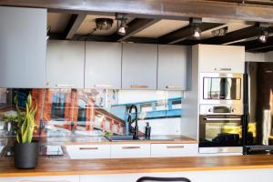 a kitchen with white cabinets and a stove at RedCity LOFT 304 in Żyrardów