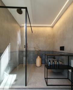 a bathroom with a shower and a glass shower stall at HomeMi Duomo Apartment in Milan