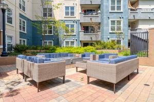 a group of chairs on a patio with buildings at San Bruno 1BR w Pool Gym WD nr highways SFO-995 in San Bruno