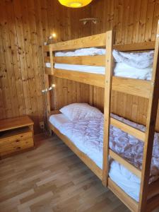 a bunk bed room with two bunk beds in a cabin at La Crettaz app dans chalet - SUNNY apartment 6 p in Veysonnaz +15 photos