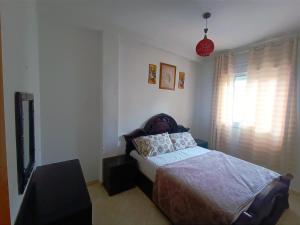 a bedroom with a bed and a television in it at Azar immobilier in Oujda