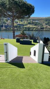 a park with a tree and a body of water at Douro in Melres