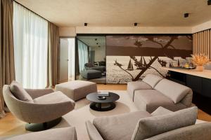 a living room with a couch and chairs and a table at Hotel Ambasador in Split