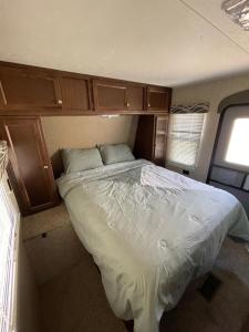 a bed in a small room in an rv at Hideout by Glampers Camp in Port Charlotte