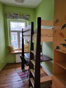a room with two bunk beds and a window at 90 sq.m. apartment in centre of Vilnius in Vilnius