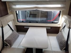 une petite chambre avec deux chaises et une fenêtre dans l'établissement FORD ZEFIRO 675 MOTORHOME, à Wigan