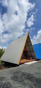 a small house with a tin roof on top of it at หวานใจ โฮมสเตย์ (Whanjai Homestay) in Laem Ngop