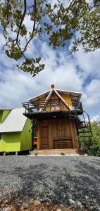 a large house with a balcony on top of it at หวานใจ โฮมสเตย์ (Whanjai Homestay) in Laem Ngop