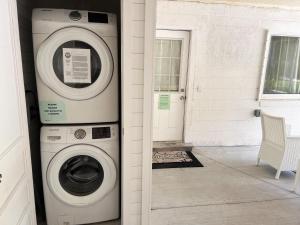 a washing machine sitting next to a house with a door at Mangrove Cove Unit 2 in Englewood