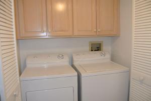 a kitchen with white appliances and wooden cabinets at Freds Santa Maria Harbour Resort Condo in Fort Myers Beach