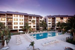a large swimming pool in front of a building at Freds Santa Maria Harbour Resort Condo in Fort Myers Beach