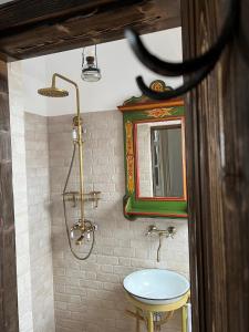 a bathroom with a sink and a mirror at Barn guesthouse / Csűr vendégház in Delniţa