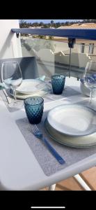 a table with plates and glasses on a table at Lugar del Sol in Costa Calma +21 photos